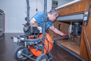 technician cleaning drain